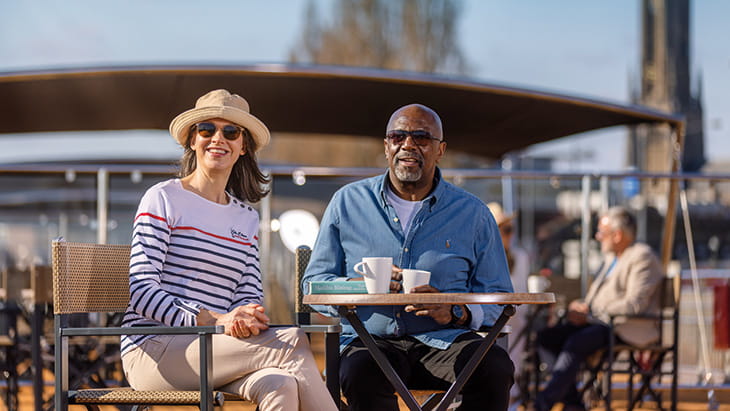 A couple enjoying drinks on Sundeck, Spirit of the Danube